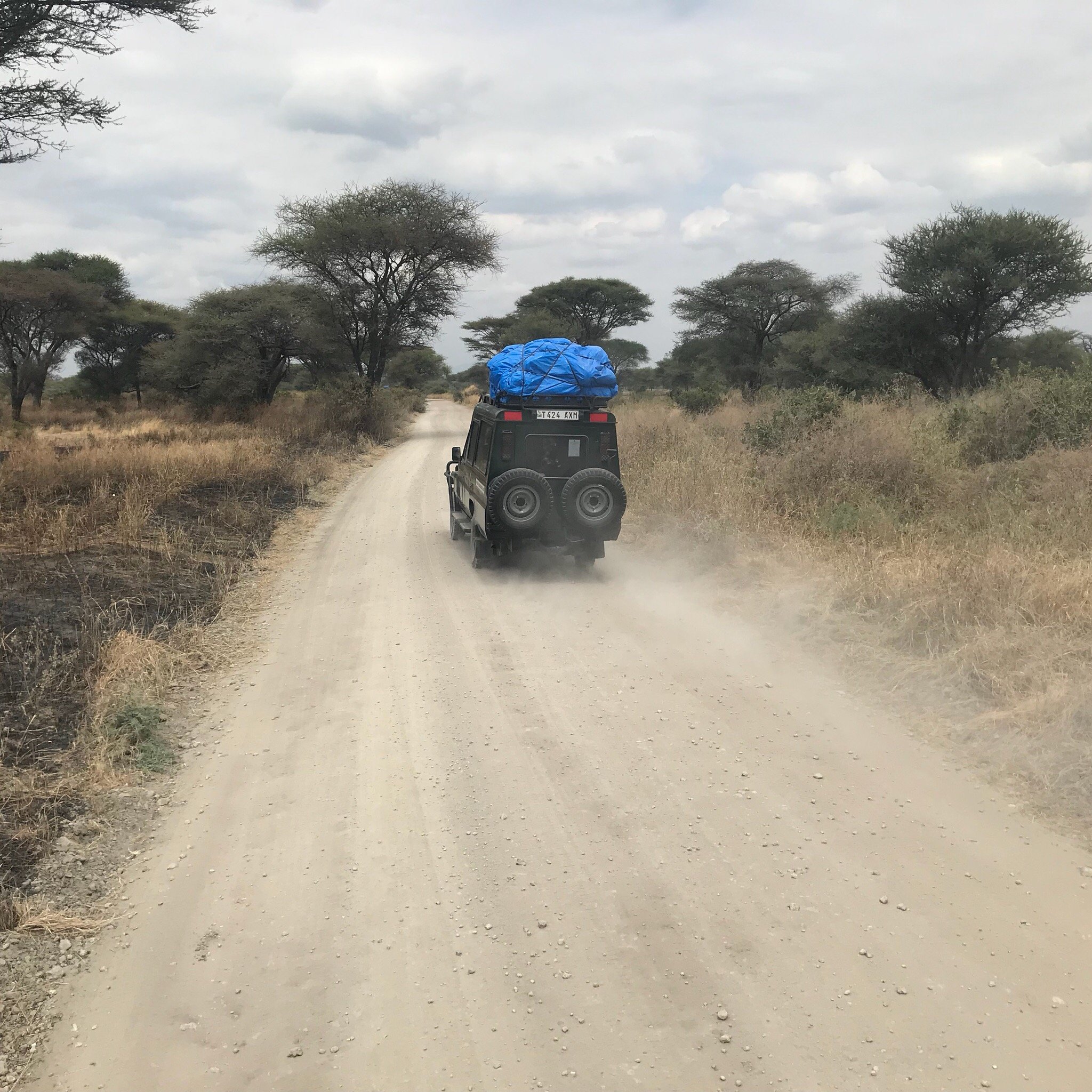 Black suv driving dirt road dry