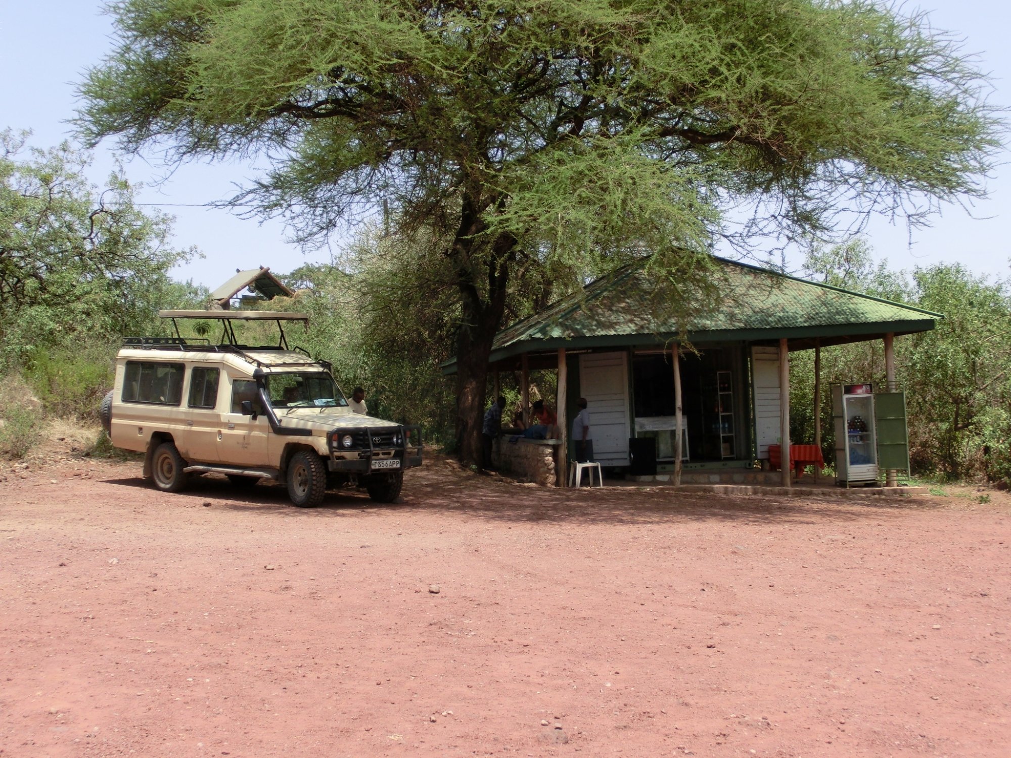 Small green roofed hut situated middle